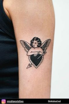 a small tattoo on the arm of a woman with an angel holding a heart and lightning bolt