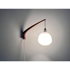 a light that is on the wall with a long arm and a bulb attached to it