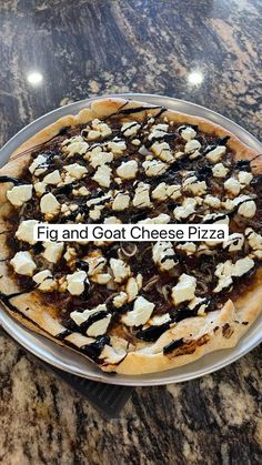 a pizza sitting on top of a metal pan covered in cheese and black olives