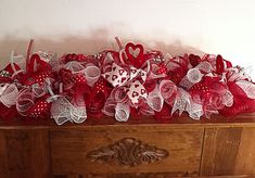 a wooden box with red and white bows on it