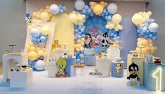 a mickey mouse birthday party with balloons and decorations