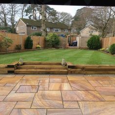 a backyard with wooden steps and green grass