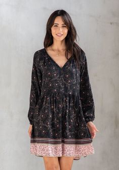 An ultra-flowy style just in time for Spring, our classic bohemian mini dress is designed in a floral border print. Featuring voluminous long sleeves and a flattering split neckline with tassel tie accents. The epitome of throw-on-and-go, this effortless style is perfect for work or play. Floral border print Relaxed fit Voluminous long sleeve Elastic wrist cuff Mini length Split v-neckline with tassel ties Classic bohemian mini dress Model is 5'10, wearing a size S.Style: I-72761W-RPV-AE Black Long Sleeve Dress With Floral Print, Long Sleeve Boho Dress With Floral Print For Fall, Black Long-sleeve Dresses With Blouson Sleeves, Black Long Sleeve Dresses With Blouson Sleeves, Black Long Sleeve Dress With Blouson Sleeves, Bohemian Flowy Dress With Blouson Sleeves, Casual Black Long Sleeve Boho Dress, Black Boho Print Long Sleeve Dress, Bohemian Long Sleeve Mini Dress With Boho Print