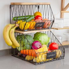 two metal baskets filled with fruits and vegetables