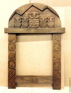 an old wooden frame with owls on it