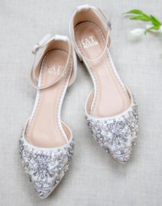 the bride's shoes are adorned with silver sequins