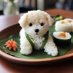 a small white dog sitting on top of a green plate filled with rice and sushi