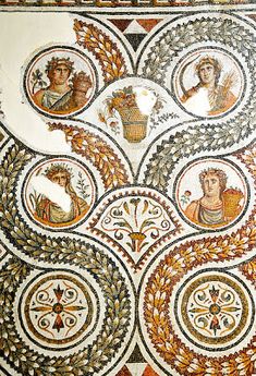 the mosaic work on the wall shows different women's heads and faces, all surrounded by circular designs