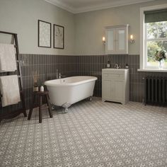 a bathroom with a white bath tub sitting next to a window