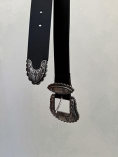 The Austin Belt by Streets Ahead adds a vintage touch to your look with this western-inspired belt featuring black Italian leather, eye-catching oversized silver buckle with engraved floral details and silver tip. Strap Width: 1.5" Buckle Height: 3.25" - Length: 2.5" Genuine Italian Leather Ethically Made in California Black Belt, Black Media, Italian Leather, Austin, Gift Card, Buckle, California, Floral, Leather