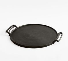 a black tray with handles on a white background, it appears to be cast iron