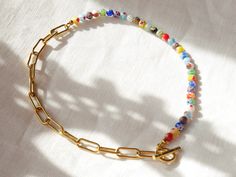 Half millefiori half chain necklace is colorful, feminine, and versatile. The colorful millefiori glass beads look lovely against the gold color of the chunky stainless steel chain. Wear it however you want - the toggle closure at the back, side, or front!  The length of the necklace is 16.5 inches (42 cm). If you want another length, just send me a message and I'll make it for you! If you want the same design, but with smaller millefiori beads and a daintier chain, you can find it here: https://www.etsy.com/listing/1533613289 ♥ Jewelry care ♥ It's important to keep your jewelry dry: Take it off before taking a shower, bath, swimming, or exercising. Always apply your makeup, perfume, and hairspray before putting on your jewelry.  Store your jewelry somewhere dry (not in the bathroom). See Multicolor Beaded Necklaces With Round Beads And Chain, Multicolor Beaded Chain Necklace, Multicolor Glass Necklace With Chain, Multicolor Glass Chain Necklace, Half Chain Necklace, Beaded Chain Necklace, Chunky Gold Chain, Necklace Colorful, Gold Earrings For Women