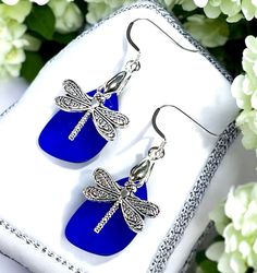 *These beautiful dragonfly earrings made with cultured sea glass in a rich Cobalt Blue color and have sterling silver ear wires.  *The silver Dragonfly charms have an antique silver finish so they will remain bright, shiny and tarnish free with proper care. I make these beautiful earrings in many different colors.Please choose the color you would like from the drop down menu. All Metal parts of these earring are Nickel Free, Lead Free and Cadmium Free. The earrings come complete with rubber earring backs and in a lovely gift box, ready for gift giving. Whether these Earrings are a gift for yourself or a loved one, these lovely earrings will be a reminder of the essence of springtime and summer all year round!! Sea Glass Dangle Earrings Gift, Nickel-free Blue Dragonfly Jewelry, Adjustable Sea Glass Earrings Gift, Beautiful Dragonfly, Glass Dragonfly, Dragonfly Jewelry, Dragonfly Charm, Jewelry Summer, Sea Glass Earrings