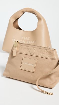 Find MARC JACOBS The Leather Mini Sack Bag on Editorialist. Pebbled cowhide,Debossed logo lettering at front,Optional zip poch included,Magnetic snap at top,Leather lining,Weight: 19oz / 0.54kg,Imported, Vietnam Leather Shoulder Bag With Logo For On-the-go, Beige Leather Shoulder Bag With Logo, Beige Logo Shoulder Bag For Everyday Use, Everyday Leather Bag With Logo, Everyday Use Logo Pouch Bag, Debossed Logo, Sack Bag, Marc Jacobs Bag, Mini Shoulder Bag