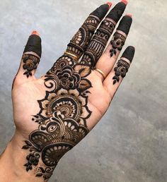 a hand with henna tattoos on it