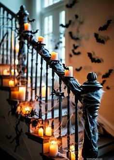 candles are lit on the banisters decorated with bats