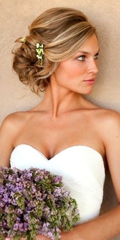 a woman holding a bouquet of flowers in her hand