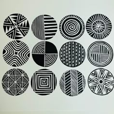 nine black and white circles are arranged in the shape of an abstract pattern on a white background