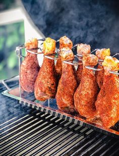 several pieces of meat are being cooked on the grill