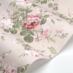 a pink flowered wallpaper with green leaves and flowers on the side, as well as white background