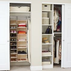 an organized closet with white shelving and hanging baskets on the door, open to reveal clothes