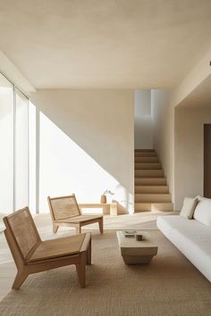 a living room filled with furniture and a stair case