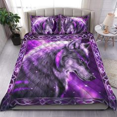 a purple bed with a wolf on it's cover and pillow cases in front of a window