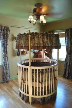 a baby crib in the middle of a room with curtains on the window sill