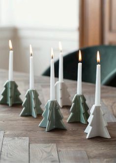 candles are lined up in the shape of christmas trees