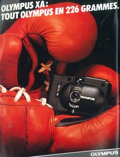 an advertisement for a camera and boxing gloves