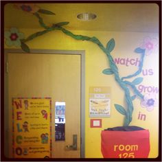 a classroom door decorated with a flower pot