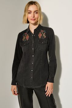 With simmering beauty and rustic appeal, the Myra denim shirt checks all the right boxes. Jewel-toned floral embroidery on the front, back yoke, and sleeves, taking the spotlight on this heavy-enzyme-washed denim shirt. Made from a uniquely comfortable cotton/linen blend, the Myra boasts a longer length and a flattering, tailored shape. Styled with western flap pockets, metal-rimmed real abalone snaps, and a fringed raw-edge hem, the mysterious Myra is a charming choice for southwest adventure—a Fitted Shirt With Floral Embroidery For Fall, Washed Denim, Jewel Tones, Raw Edge, Denim Shirt, Denim Wash, Floral Embroidery, Cotton Linen, Linen Blend