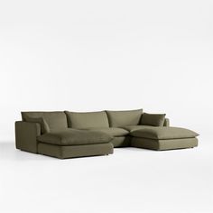 a large sectional couch with pillows on the top and bottom, sitting in front of a white background