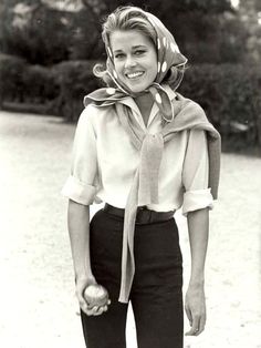 black and white photograph of a woman holding an apple