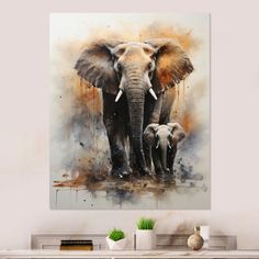 an elephant and her baby are standing in front of a wall hanging on the wall