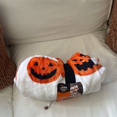 two orange and white towels with jack - o'- lanterns on them sitting on a chair