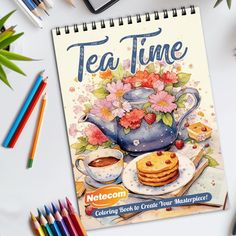 the cover of tea time cookbook is next to colored pencils