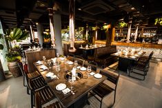 an empty restaurant with tables and chairs set up for two people to sit at the table