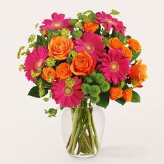 a vase filled with orange and pink flowers