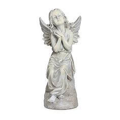 an angel statue with its arms crossed and hands folded in front of her chest, on a white background