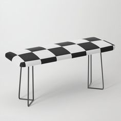 a black and white checkered bench with metal legs