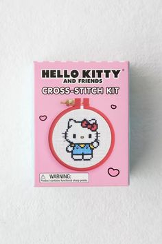 the hello kitty cross stitch kit is on display