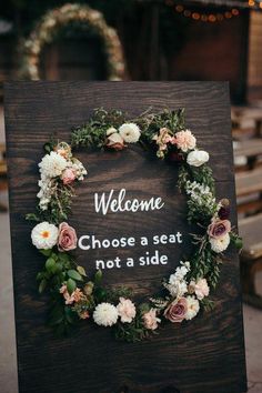 a wooden sign with flowers on it that says, welcome choose a seat not a side