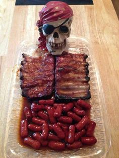 a skull sitting on top of a table next to bacon