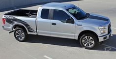 a silver truck parked in a parking lot