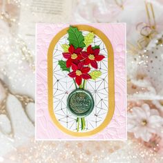 a card with poinsettis on it and a wax stamp in the middle