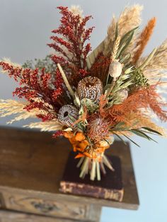 a vase filled with lots of different types of flowers