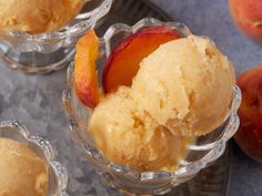 three ice creams with peaches in small glass dishes