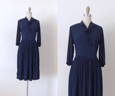 A classic 1940s navy blue rayon day dress with long sleeves and elegant silhouette. The dress has a pointed collar that ties at the neck, and a lovely full skirt. The longer sleeves and medium weight of the fabric make this a perfect dress for autumn or winter wear. The inside face of the rayon fabric is smooth and glossy, making it very comfortable against the skin. The dress closes with a gold side metal zipper. As seem from its construction, this was clearly a high quality dress in its time. Winter Evening Dresses, Long Sleeve Dress Winter, Long Sleeve Navy Dress, Vintage Retro Clothing, Dress Dark Blue, Dresses 40s, Dress Winter, 1940s Dresses, Retro Clothing