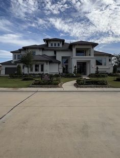 a large white house sitting on the side of a road